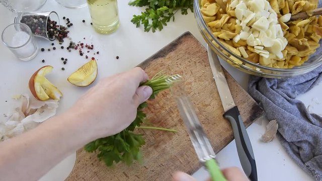 Personal perspective of woman hands cooking Amanita caesarea (known as Caesar's mushroom)