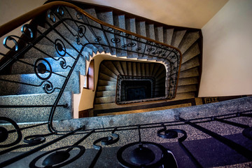 Beautiful spiral staircase with decorative metallic handrails  in old ancient house