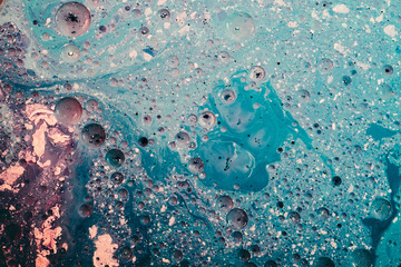Abstract art background. Blue and white wet paint mixture. Stained bubbled textured surface.