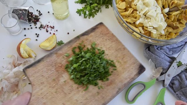 Personal perspective of woman hands cooking Amanita caesarea (known as Caesar's mushroom)