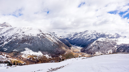 Obraz premium Beautiful mountains in winter, slopes and pistes with ski lifts, ski and snowboard holidays, Livigno village, Italy, Alps