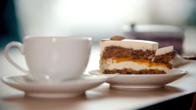 Girl breaking off a piece of cake with a fork