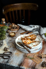 baked pears cut in half with ricotta, granola, pine nuts on ceramic plate