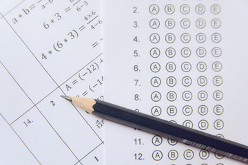 Pencil on answer sheets or Standardized test form with answers bubbled. multiple choice answer sheet