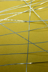 This is a photograph of a geometric design created using Blue tape applied onto a Yellow paper