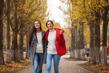 Two girlfriends in a gray wool coat and a red down jacket