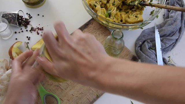 Personal perspective of woman hands preparing Amanita caesarea (known as Caesar's mushroom). Put the mushrooms in jars in oil