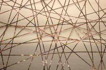 This is a photograph of a geometric design created using colorful tape applied onto a paper