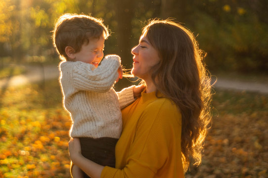 Mother and son walking in the Park and enjoying the beautiful autumn nature