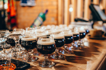 Glasses of beer on wooden bar counter. Bar on background