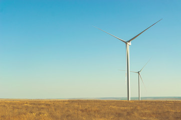 Windmills turbine modern generator on the field for alternative ecology electric energy