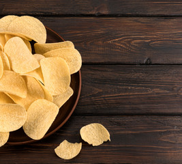 chips in a plate on a wooden background