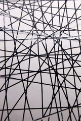 This is a photograph of a geometric design created using Black tape applied onto a White paper