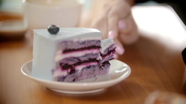 Breaking off a piece of cake with a fork