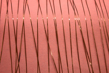 This is a photograph of a geometric design created using Rose gold tape applied onto a Pink paper