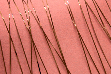 This is a photograph of a geometric design created using Rose gold tape applied onto a Pink paper
