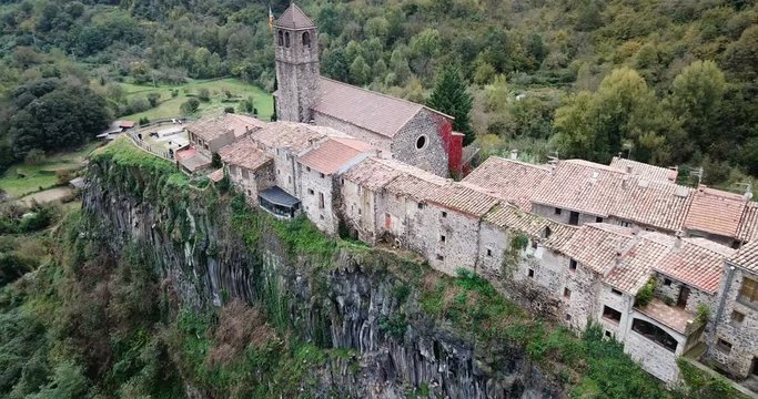 Aerial view of Castellfollit de la Roca, medieval Catalan hamlet on cliff on autumn day