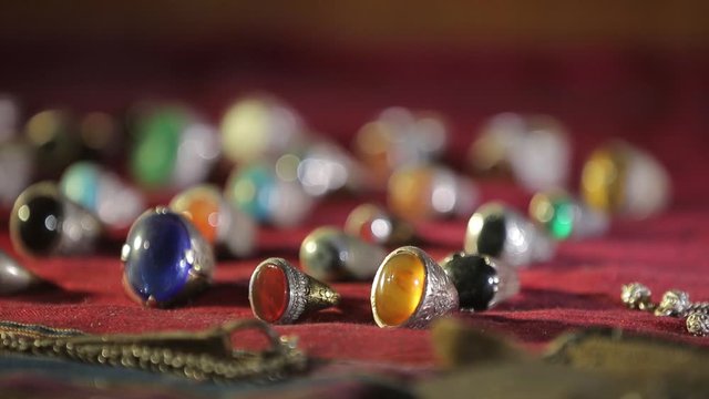 Ancient oriental rings with multi-colored precious stones. A large collection of different rings. Defocus close-up
