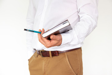 A man holds in his hands a notebook, notebook, diary and pen. Business concept isolated on white background.