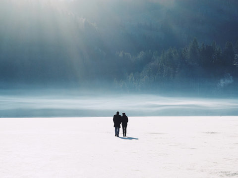 Silhouette of couple walking in winter landscape