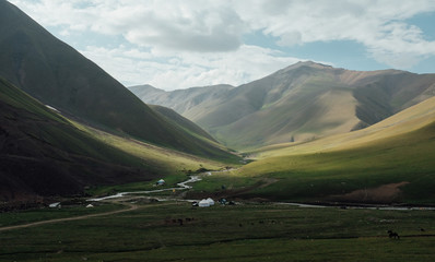 Scenic view of valley with streams amidst hills