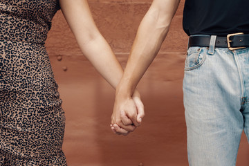 Close up of two people holding hands