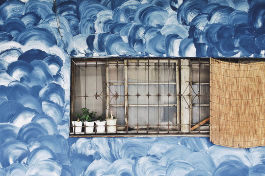 Blue swirls on wall with window