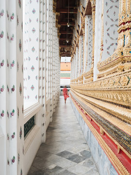 Rear view of woman walking in ornate Asian arcade