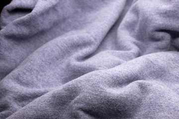 This is a photograph of textured light Purple fabric background