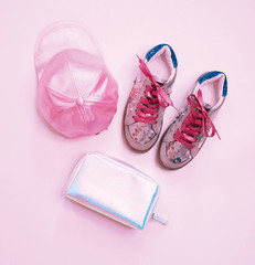 fashion creative sneakers, with pink shiny laces and silver sequins, pink satin cap and shiny holographic clutch. Fashion trend accessory