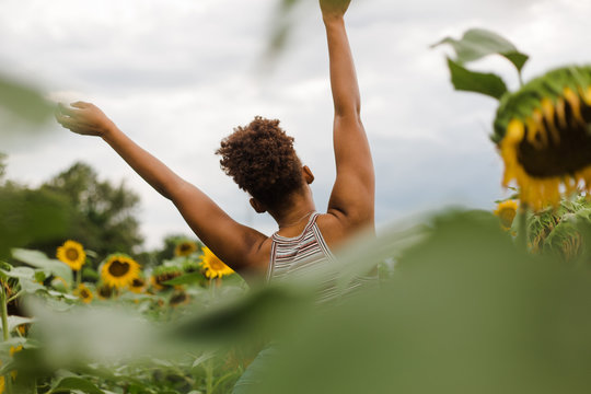 Back View Of Woman With Hands Stretched In Air