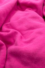 This is a photograph of textured Fuschia Pink fabric Background