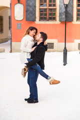 young loving couple on natural winter background. New Year and Christmas.