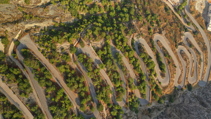 Aerial drone top down photo of snake serpentine narrow road leading uphill