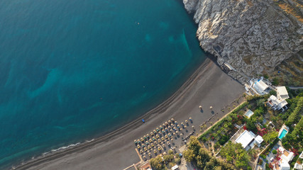 Aerial drone photo of famous seaside village and organised with sun-beds and umbrellas sandy beach...