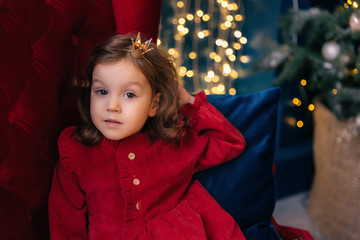 portrait of a girl in a red dress with a tiara on her head. girl