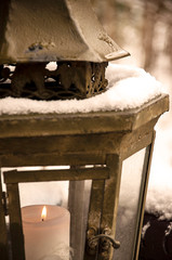 Fototapeta na wymiar Burning candle in a lantern with snow_detail by jziprian