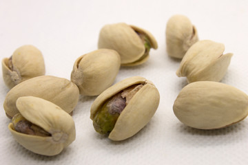 This is a photograph of Pistachios isolated on a White background