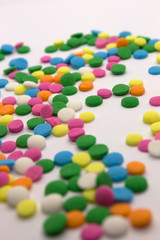 Fototapeta na wymiar This is a photograph of colorful round sprinkles isolated on a White Background