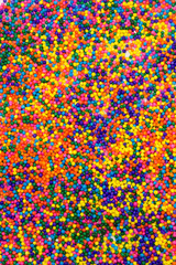 This is a background of colorful neon colored round sprinkles background