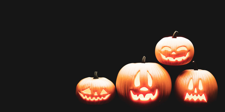 Four lighting halloween pumpkins with black background