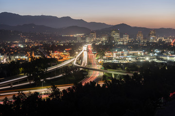 Dawn view of commuters on the Route 134 Ventura freeway in Glendale and Los Angeles, California.  Shot from Griffith Park looking east towards the San Gabriel Mountains.