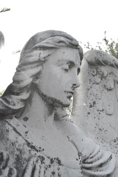 Sad angel as a symbol of eternity, life, death and afterlife. Vintage image of a sad angel in a cemetery. Angel and guardian.