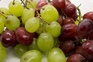 Naklejka na ściany i meble This is a photograph of Green and Red Grapes isolated on a White background