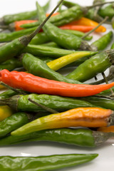 This is a photograph of Thai Chili peppers isolated on a White background