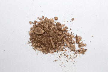 This is a photograph of a Bronze metallic powder Eyeshadow isolated on a White background