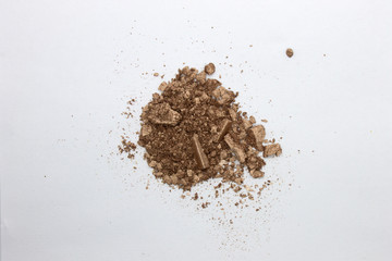 This is a photograph of a Bronze metallic powder Eyeshadow isolated on a White background
