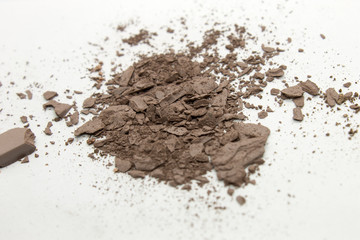 This is a photograph of a pale Brown matte powder Eyeshadow isolated on a White background