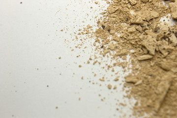 This is a photograph of a Bisque powder eyeshadow isolated on a White background