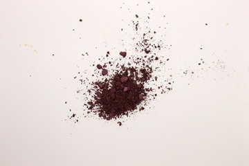 This is a photograph of a Berry Red powder Eyeshadow isolated on a White background